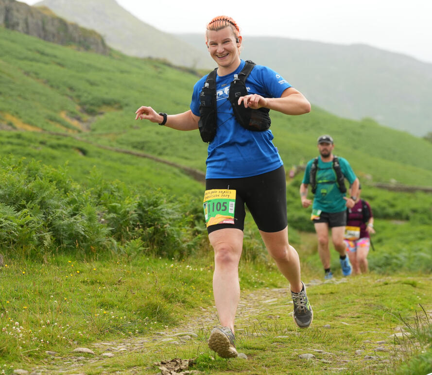 Photo of Sophia running a race in nature